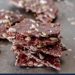 Dark chocolate bark with seeds stacked in a pile
