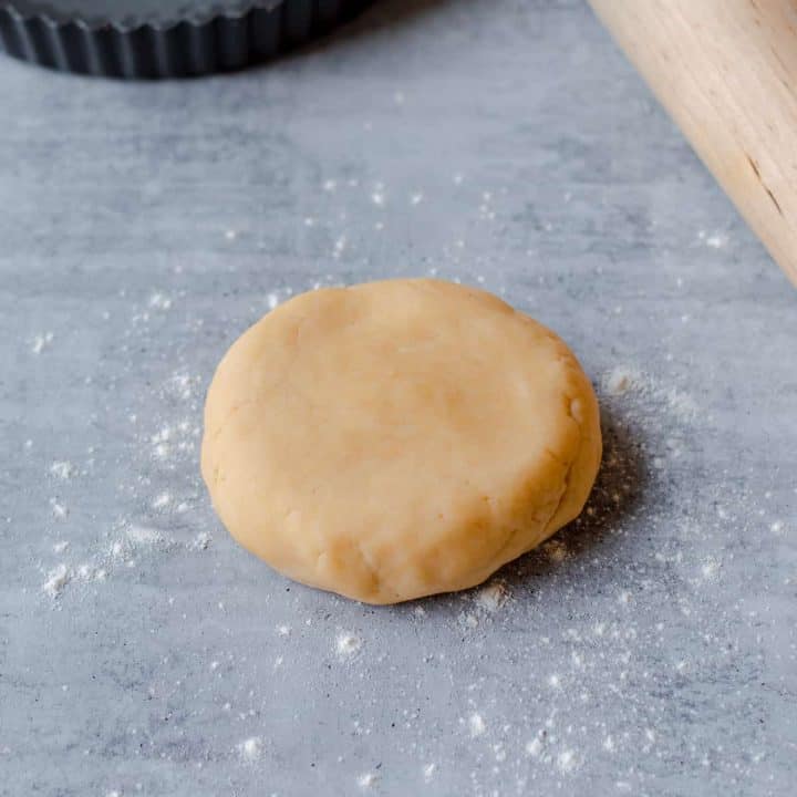 Raw Sweet Shortcrust Pastry with rolling pin and baking tray
