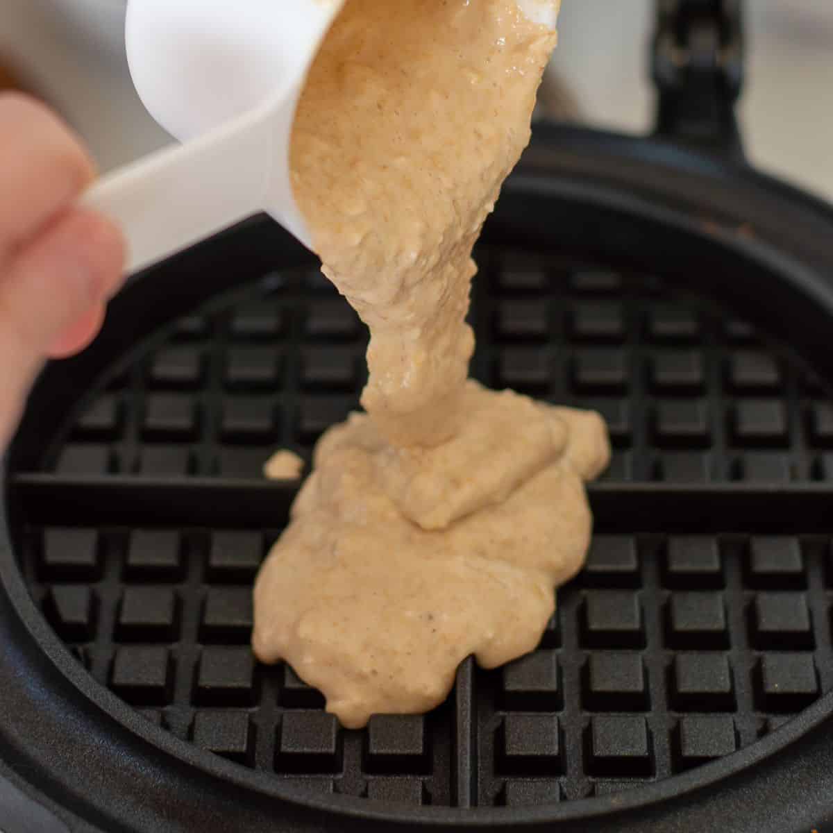 Batter poured into a waffle iron.