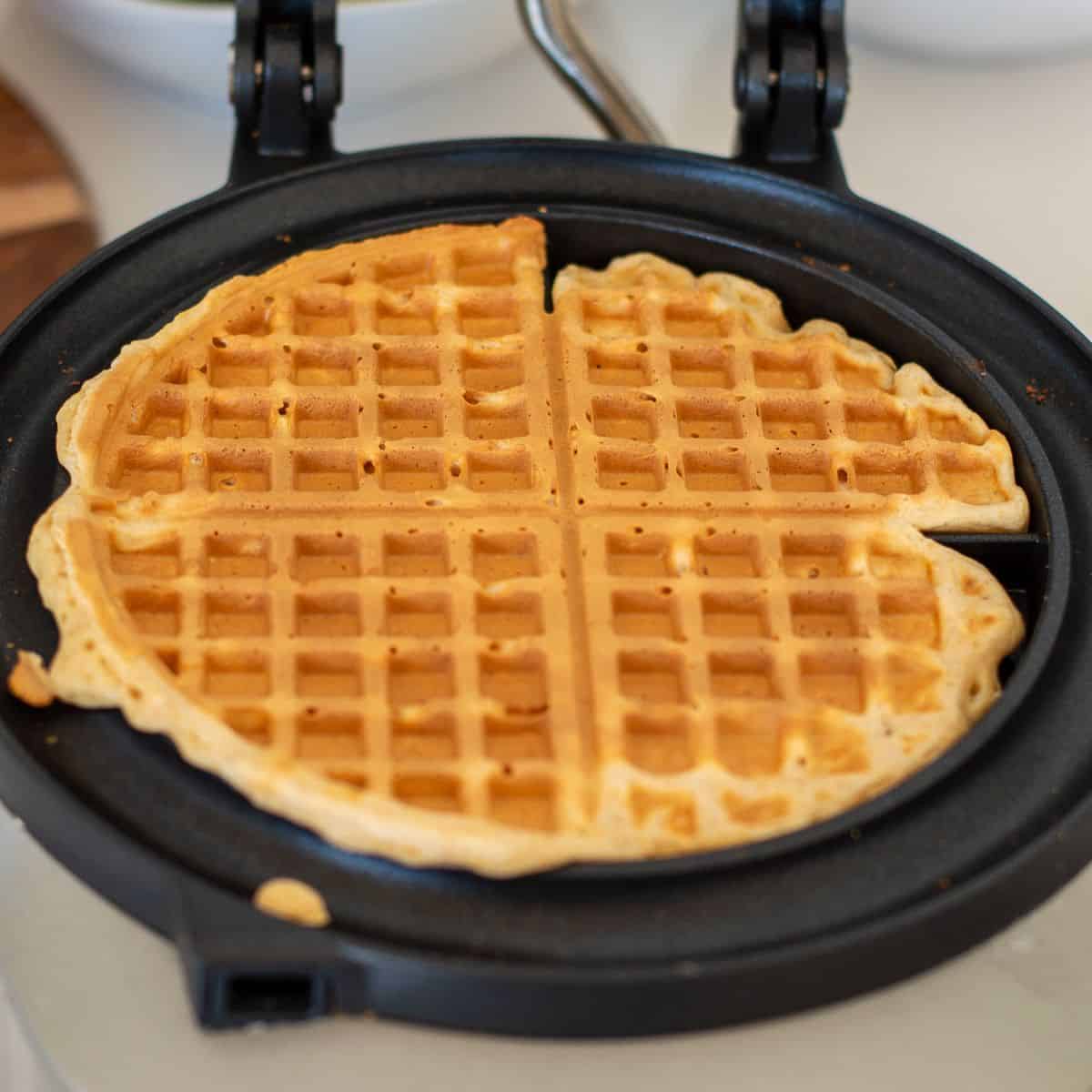 Cooked waffles in a waffle iron.