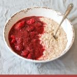 Apple and Rasberry Compote with porridge in a white bowl