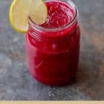Beetroot Carrot and Pear Juice in glass jar with lime wedge