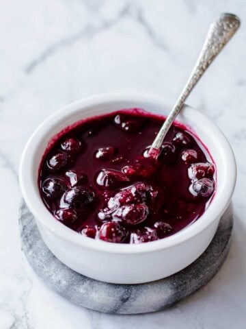 Homemade Blueberry Compote in white bowl with spoon