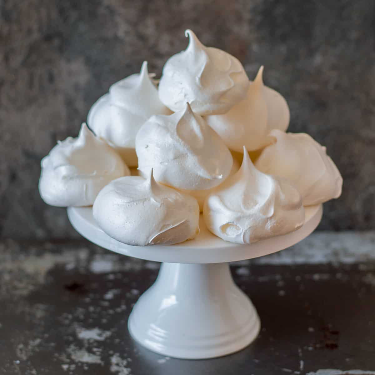 Small meringues piled up on a cake stand