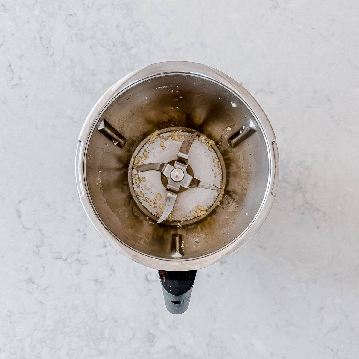 Chopped garlic in a Thermomix bowl.