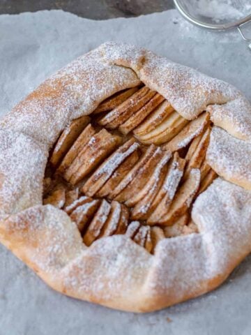 Apple Galette on baking paper waiting to be sliced
