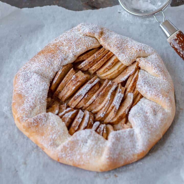 Apple Galette on baking paper waiting to be sliced