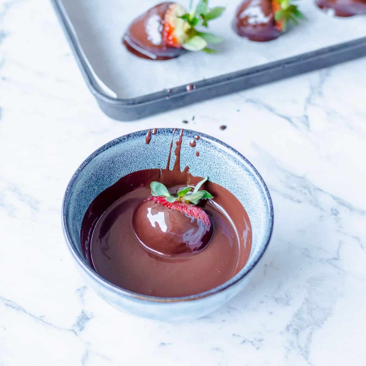 A strawberry dipped in melted chocolate.