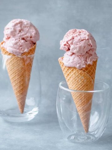 Two Homemade Strawberry Ice Creams in waffle cones