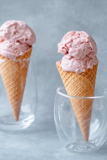 Two Homemade Strawberry Ice Creams in waffle cones