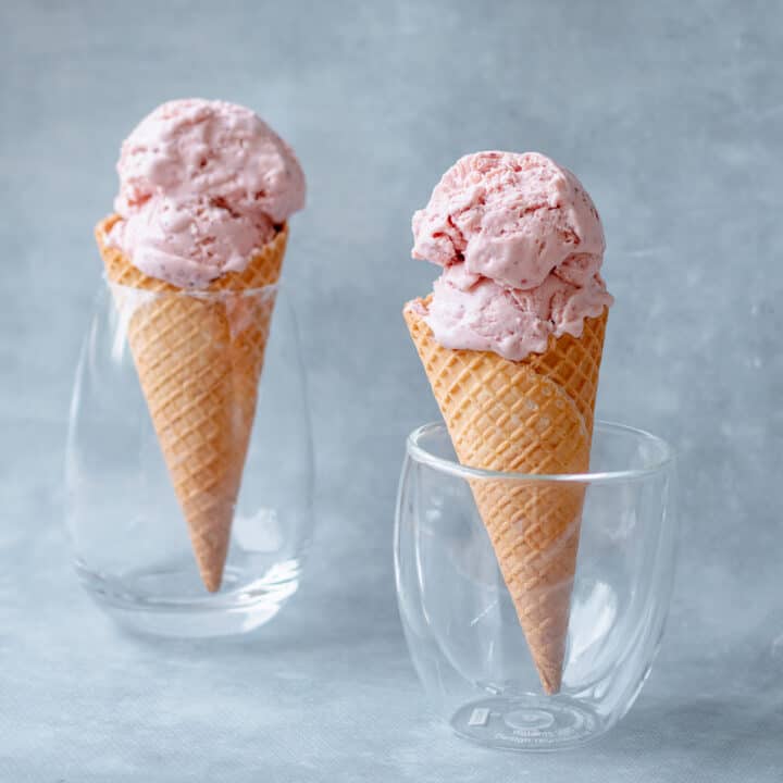 Two Homemade Strawberry Ice Creams in waffle cones