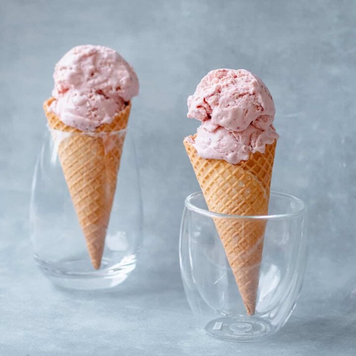 Two Homemade Strawberry Ice Creams in waffle cones