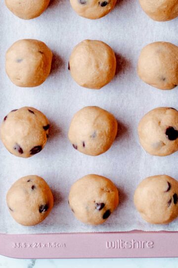 Cookie dough balls on baking sheet