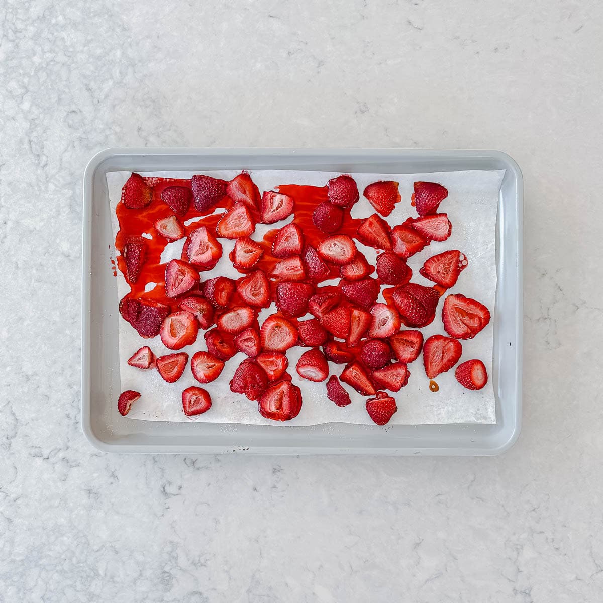 Roast strawberries on a baking tray.