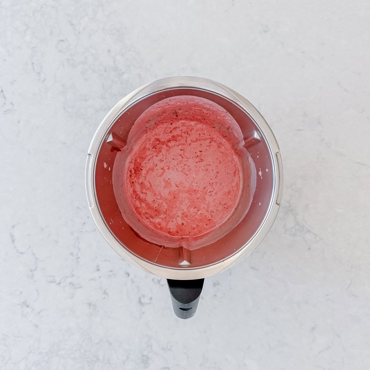 Blended strawberry and sweetened condensed milk in a Thermomix bowl.