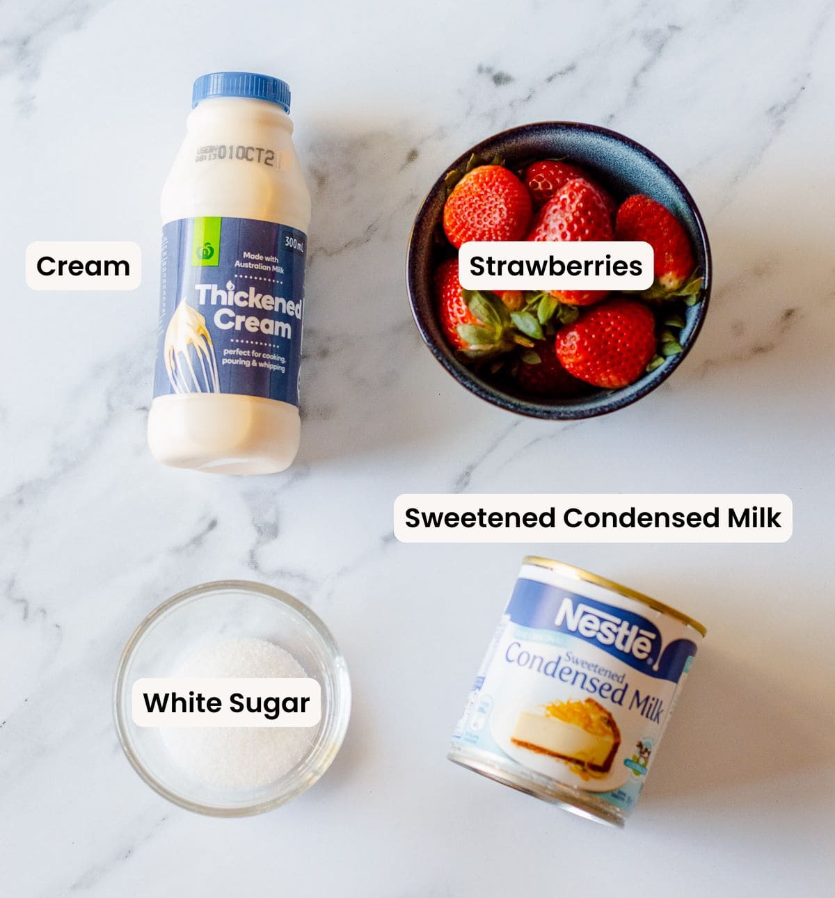 A collection of ingredients needed to make Strawberry Ice Cream.