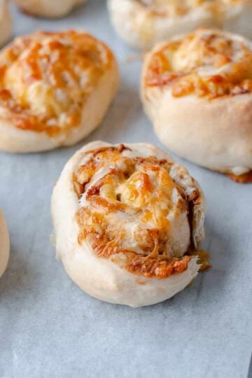 Cheese & Vegemite Scrolls on greaseproof paper