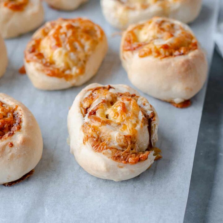 Cheese & Vegemite Scrolls on greaseproof paper