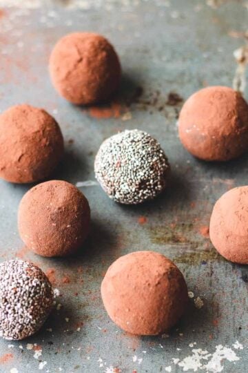 Chocolate chia bliss balls sitting on a baking sheet.
