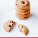 A stack of chocolate chip cookies on a marble benchtop