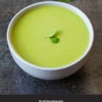 Pea and Mint Soup in a grey bowl with mint leaves