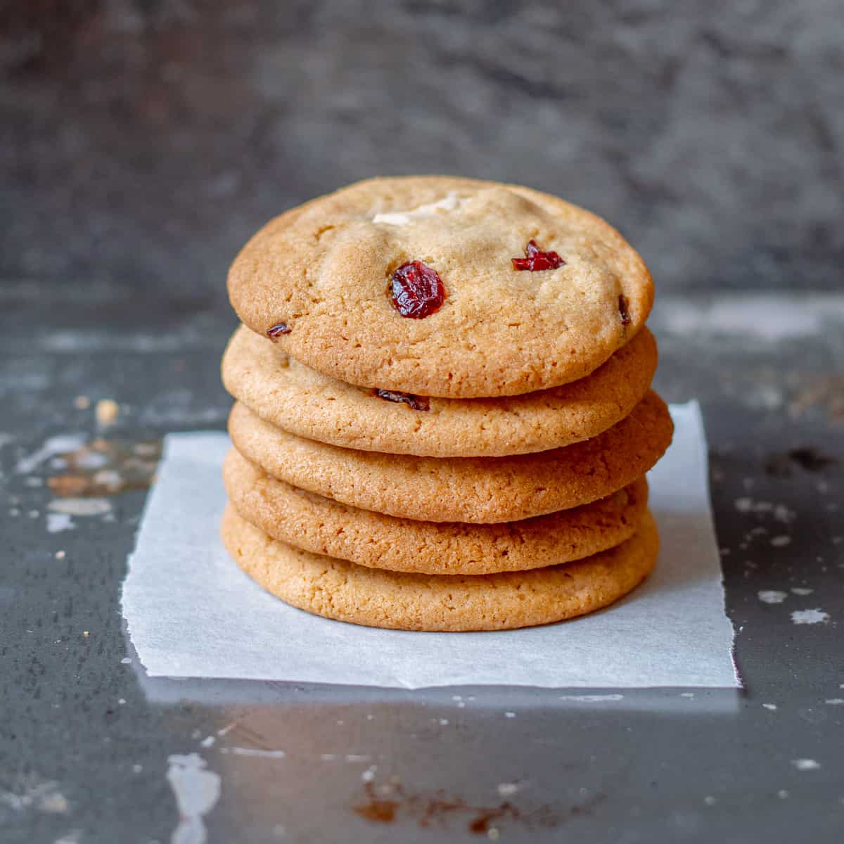 5 white chocolate and cranberry cookies in a stack