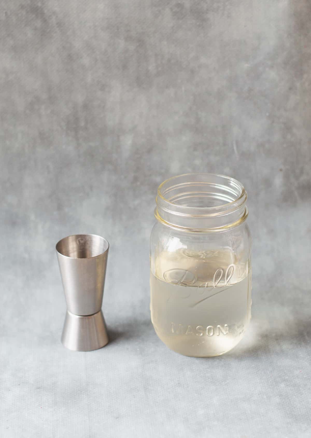 sugar syrup in glass jar with spirit measurer