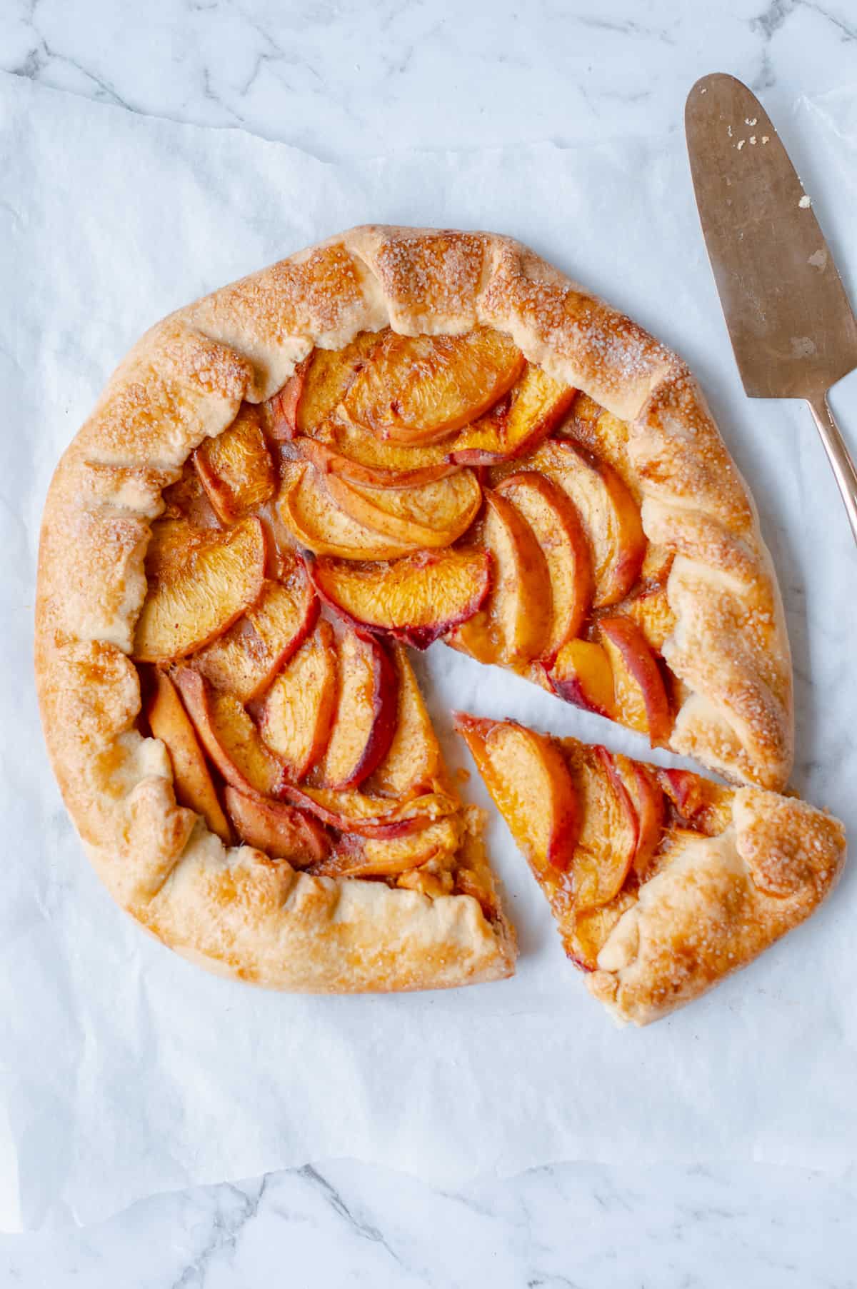 peach galette sliced with a tart slice