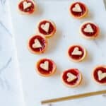 Heart shaped Jam Tarts on a marble tray.