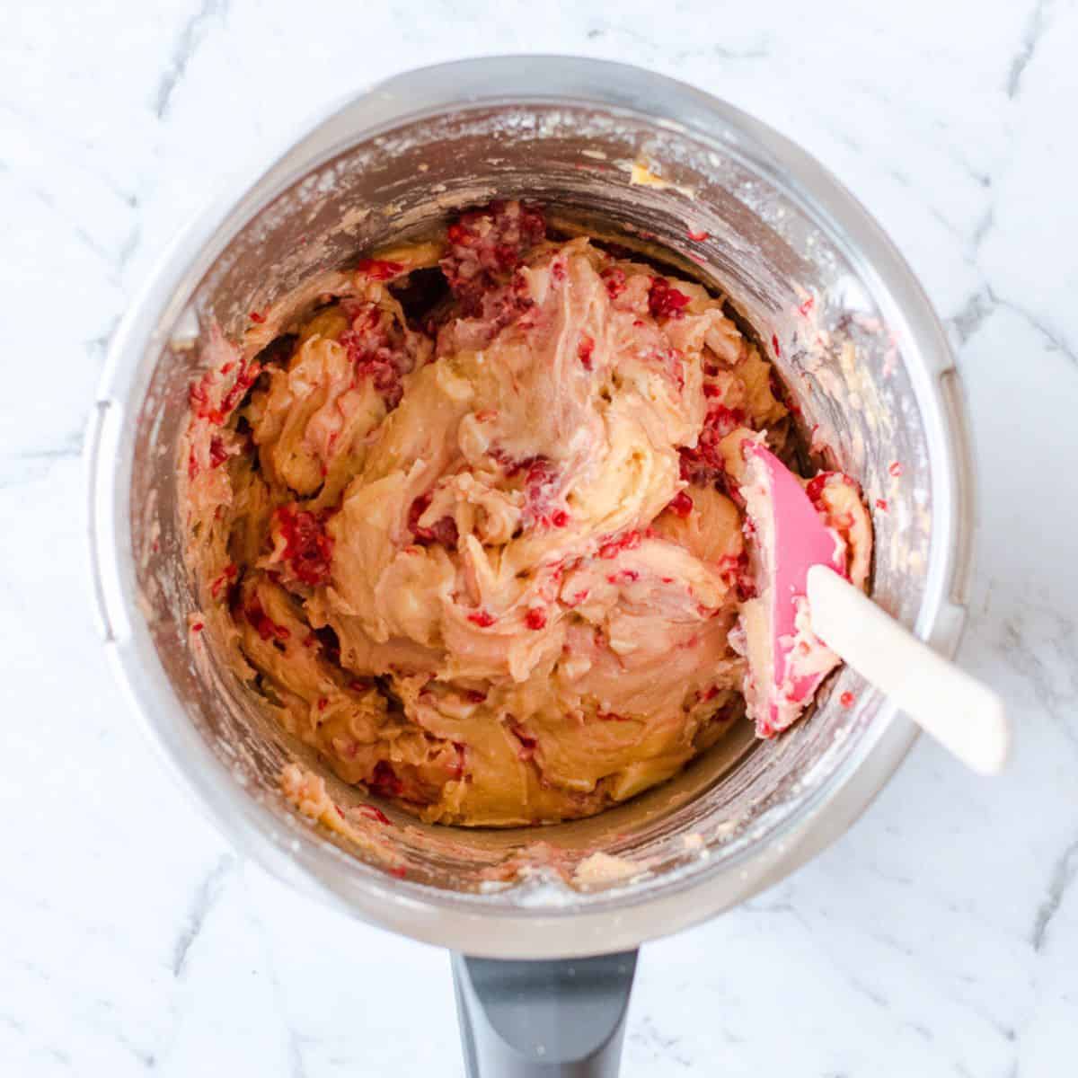 Raspberry and white chocolate batter in a thermomix bowl.