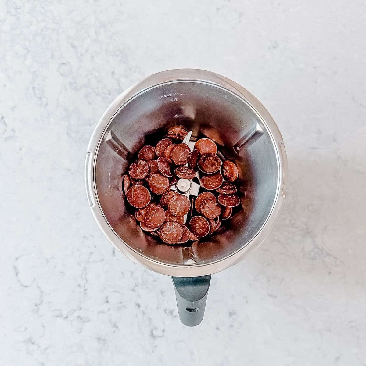 Chocolate buttons in a Thermomix bowl.