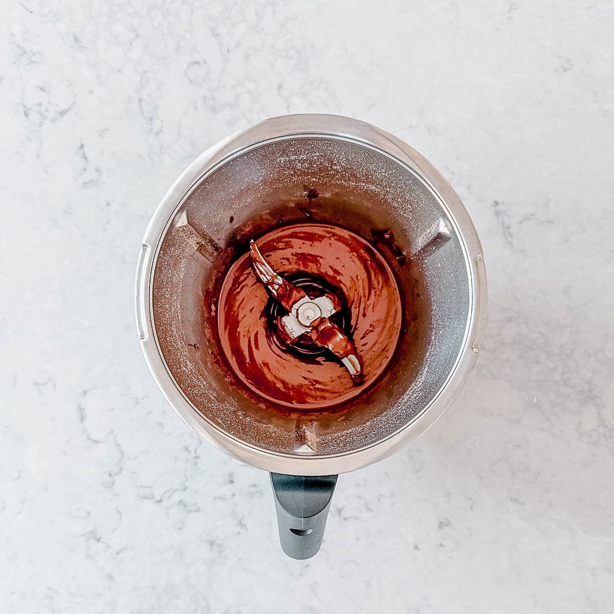 Melted chocolate in a thermomix bowl.