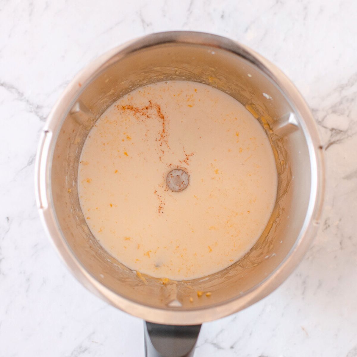 Milk and nutmeg added to the Thermomix bowl in preparation to make a bechamel sauce.