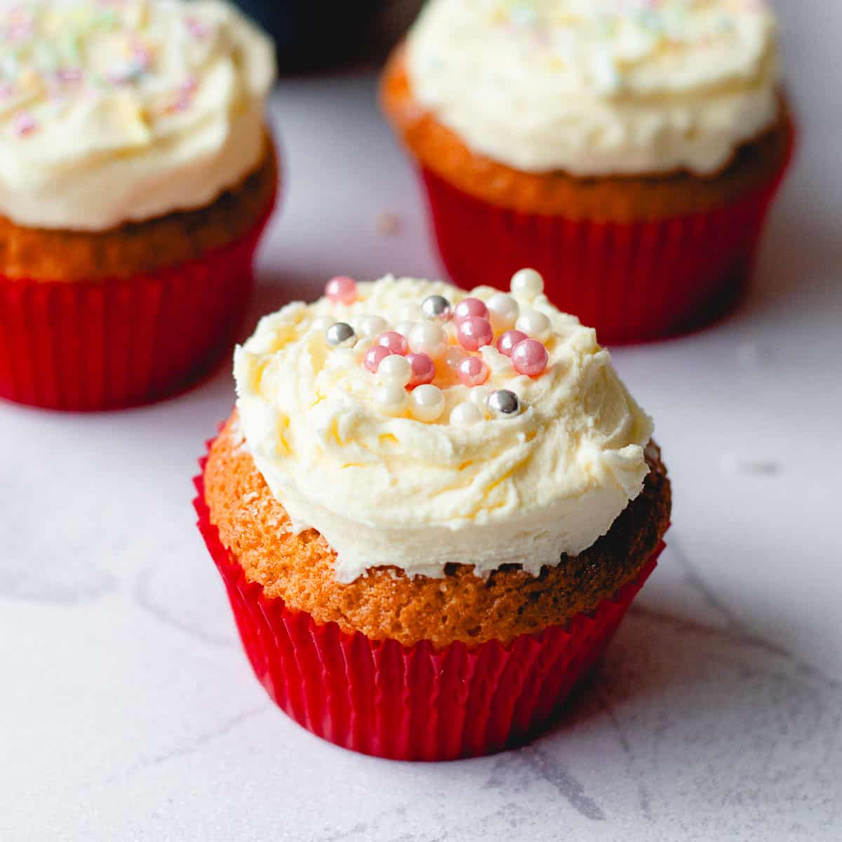 Buttercream icing with tiny pink and silver balls for decoration.