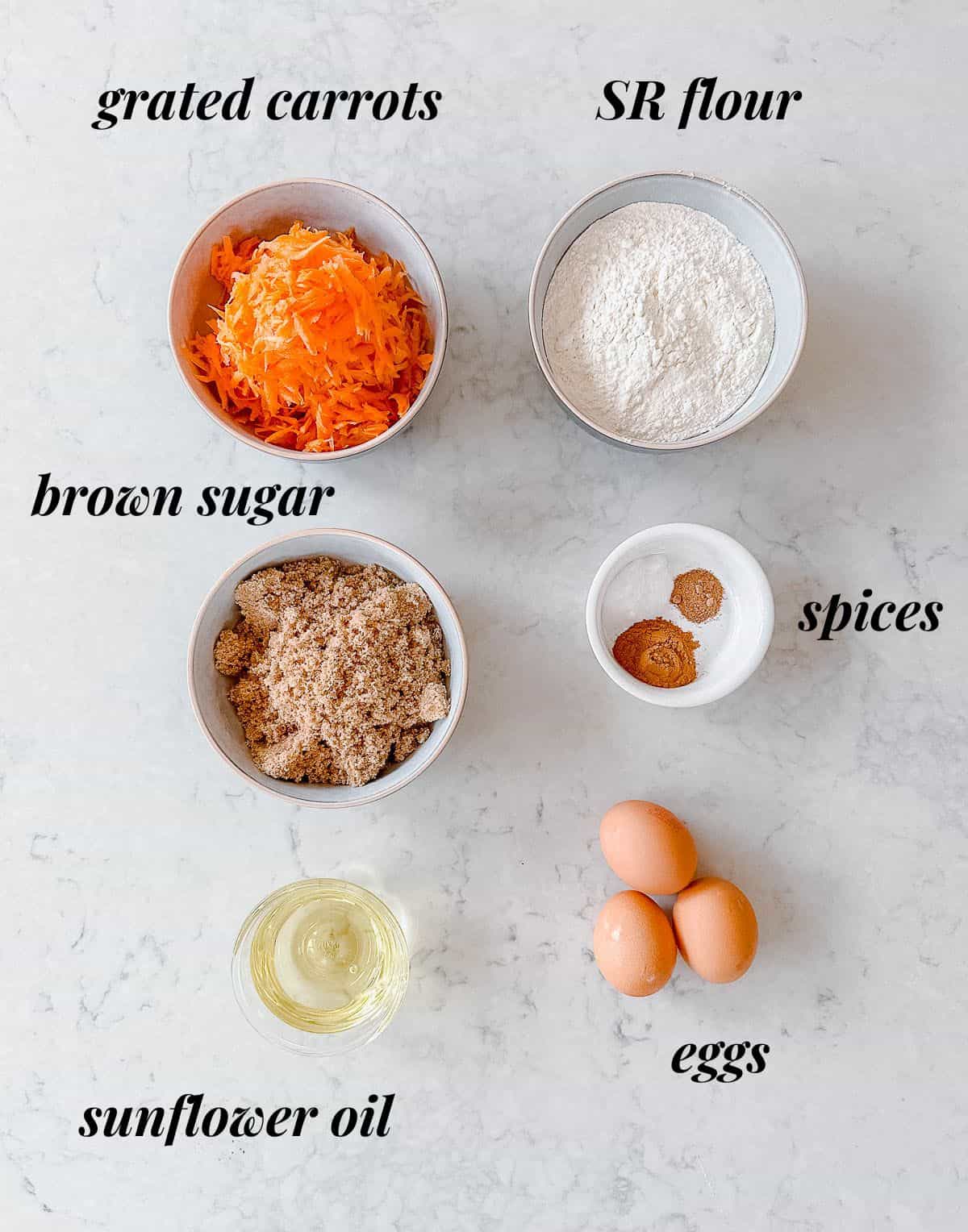 A collection of ingredients used to make Carrot Cake.