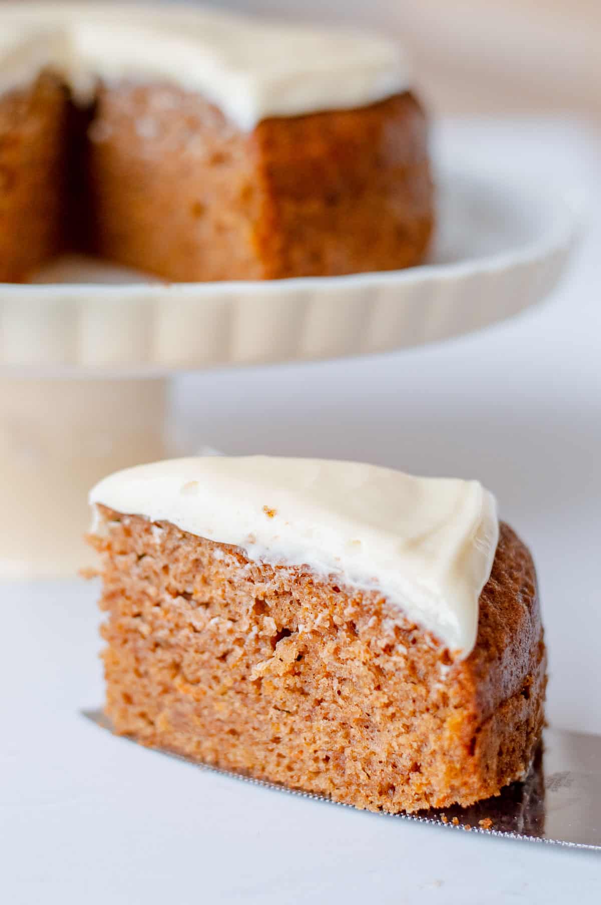 A slice of carrot cake with cream cheese icing.