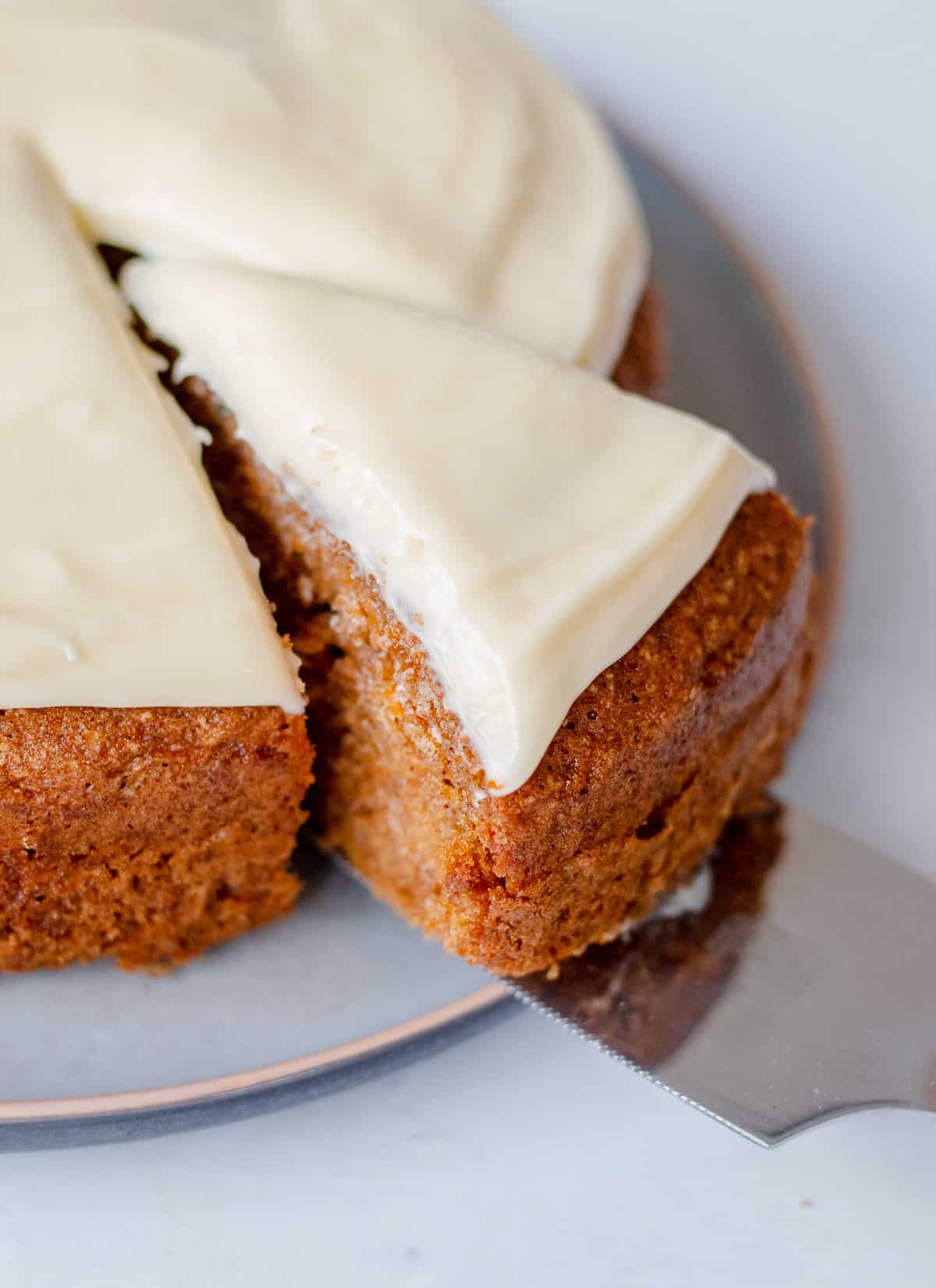 A slice of carrot cake with cream cheese icing.