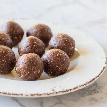 Peanut butter bliss balls on a white plate.