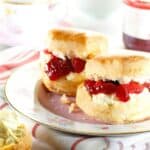 Scones with jam and cream on a plate.