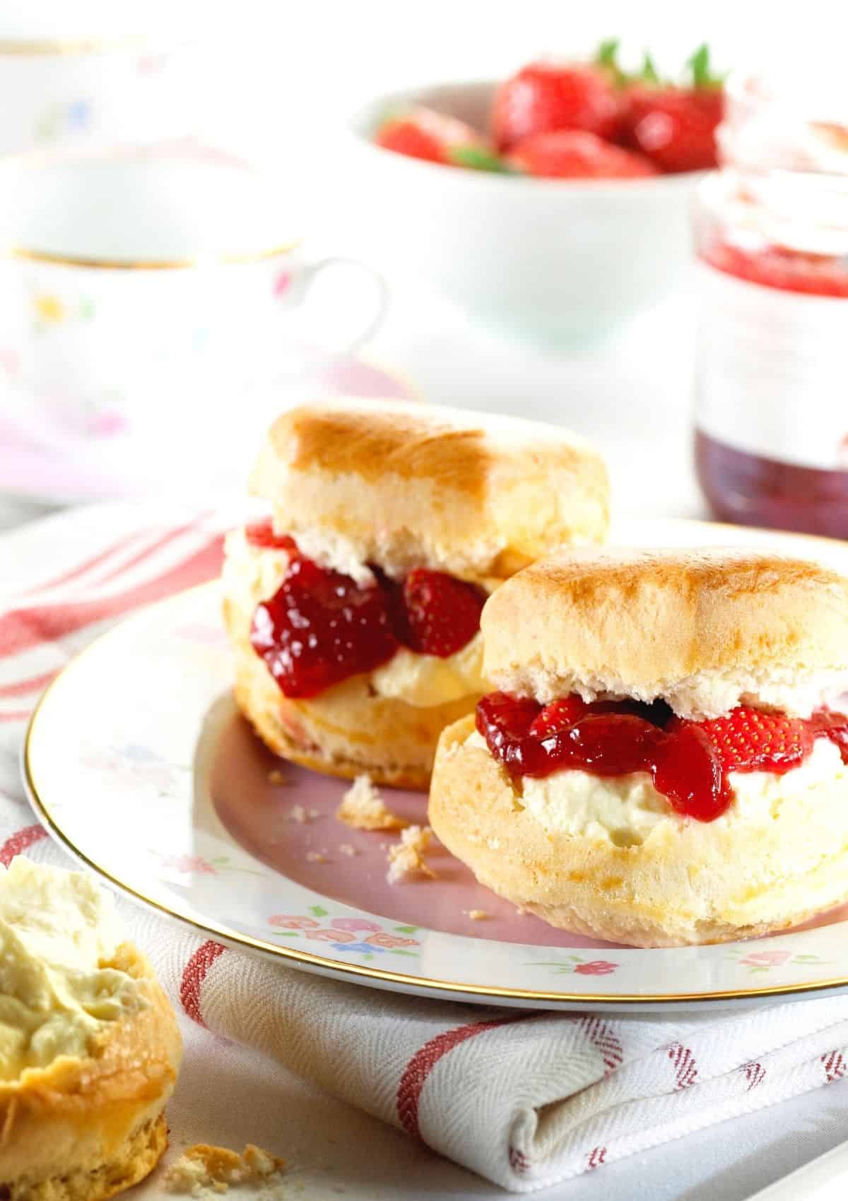 Homemade scones with cream and strawberry jam.