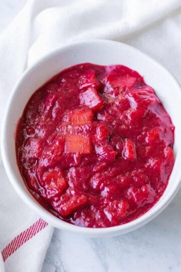 Stewed rhubarb compote in a white bowl.