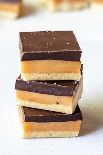 stack of 3 caramel slices on a white background.