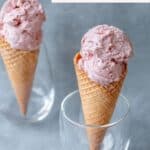 2 waffle cones filled with strawberry ice cream.