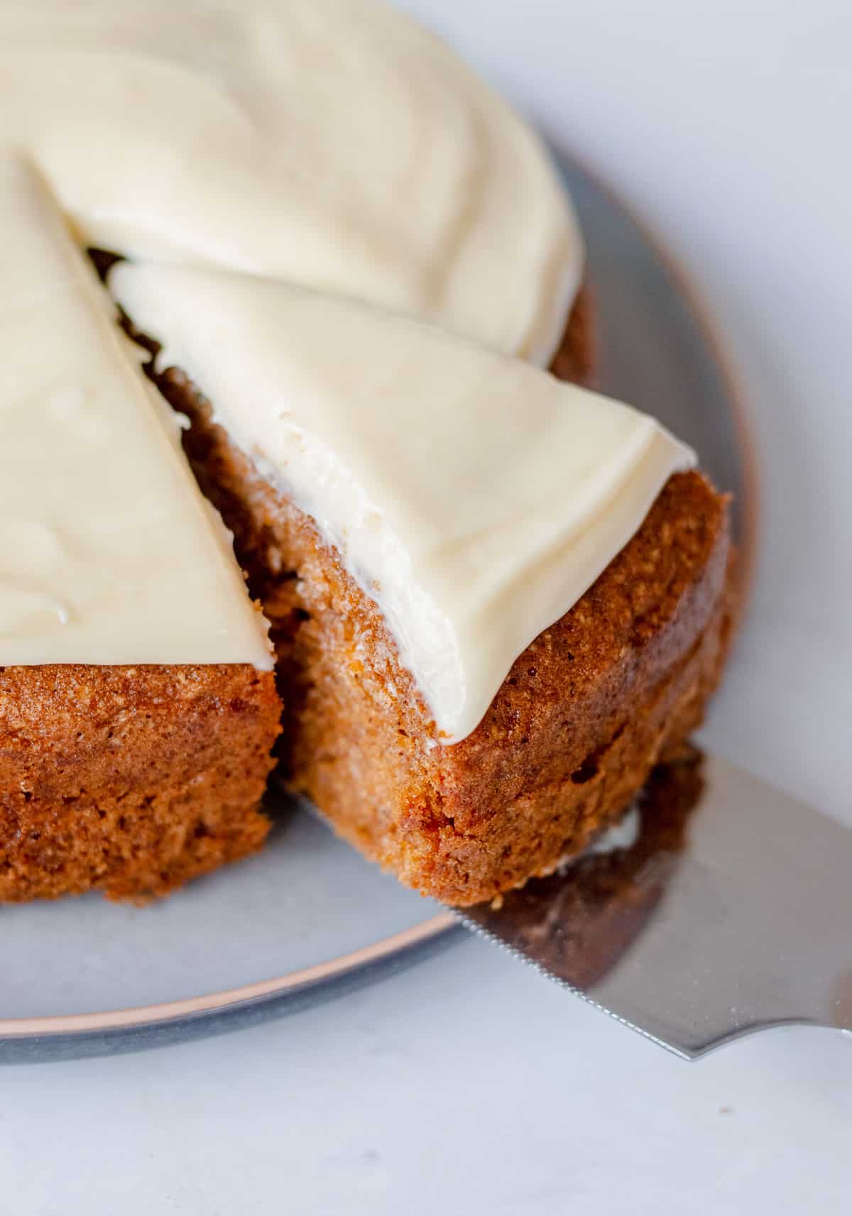  A slice of carrot cake with cream cheese icing.