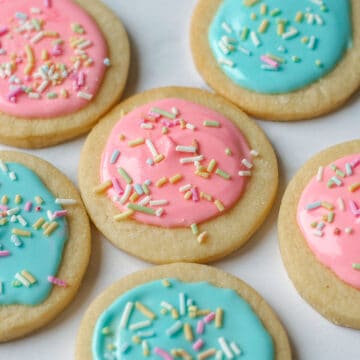 Close up image of sugar cookies decorated with pink and blue icing.