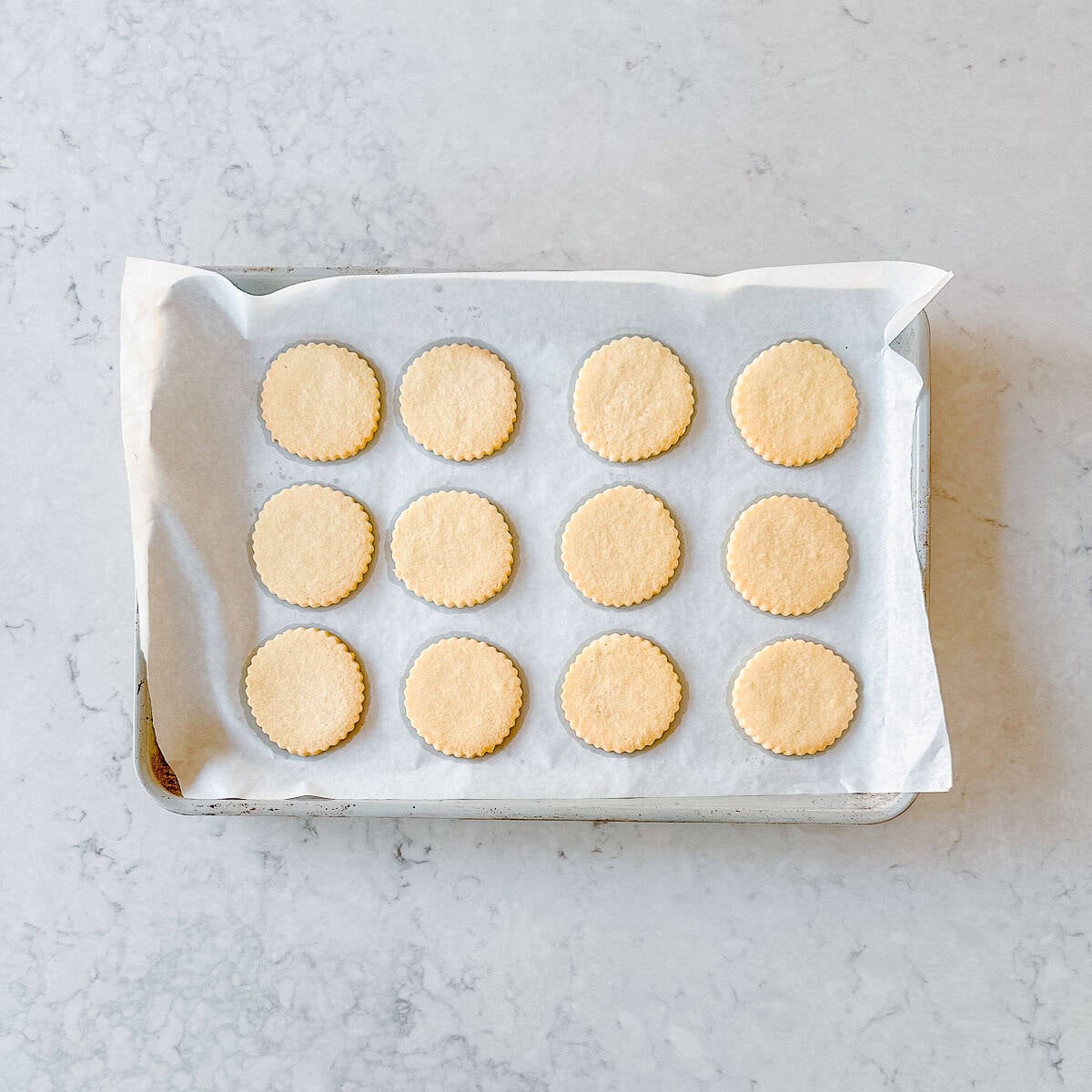 Baked sugar cookies on a baking tray.