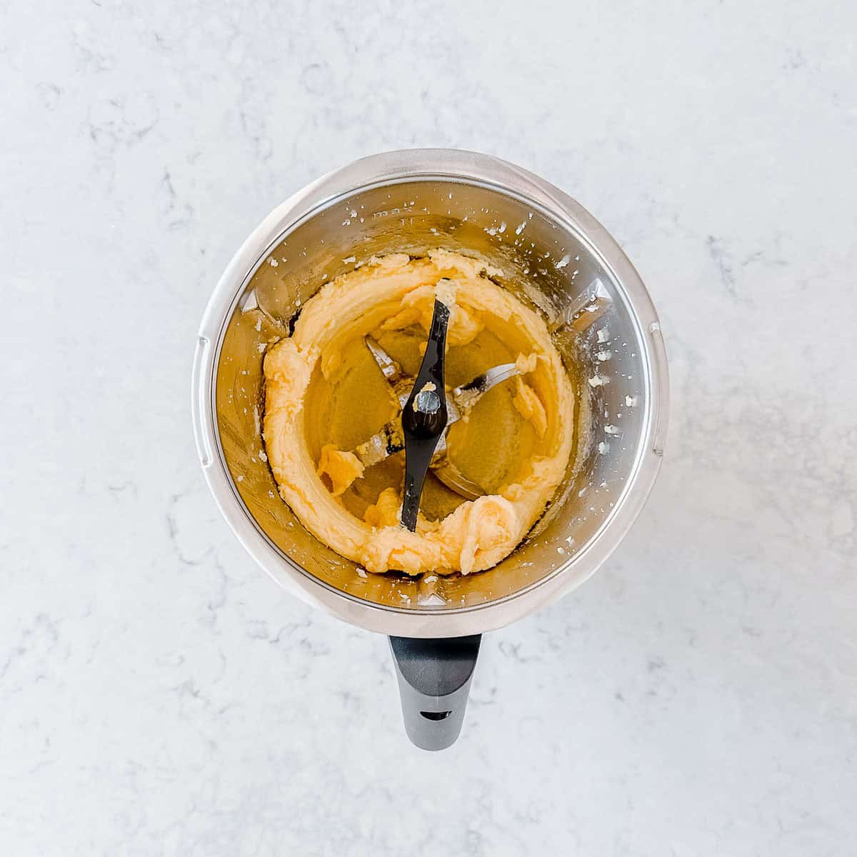 Cookie batter in a Thermomix bowl.