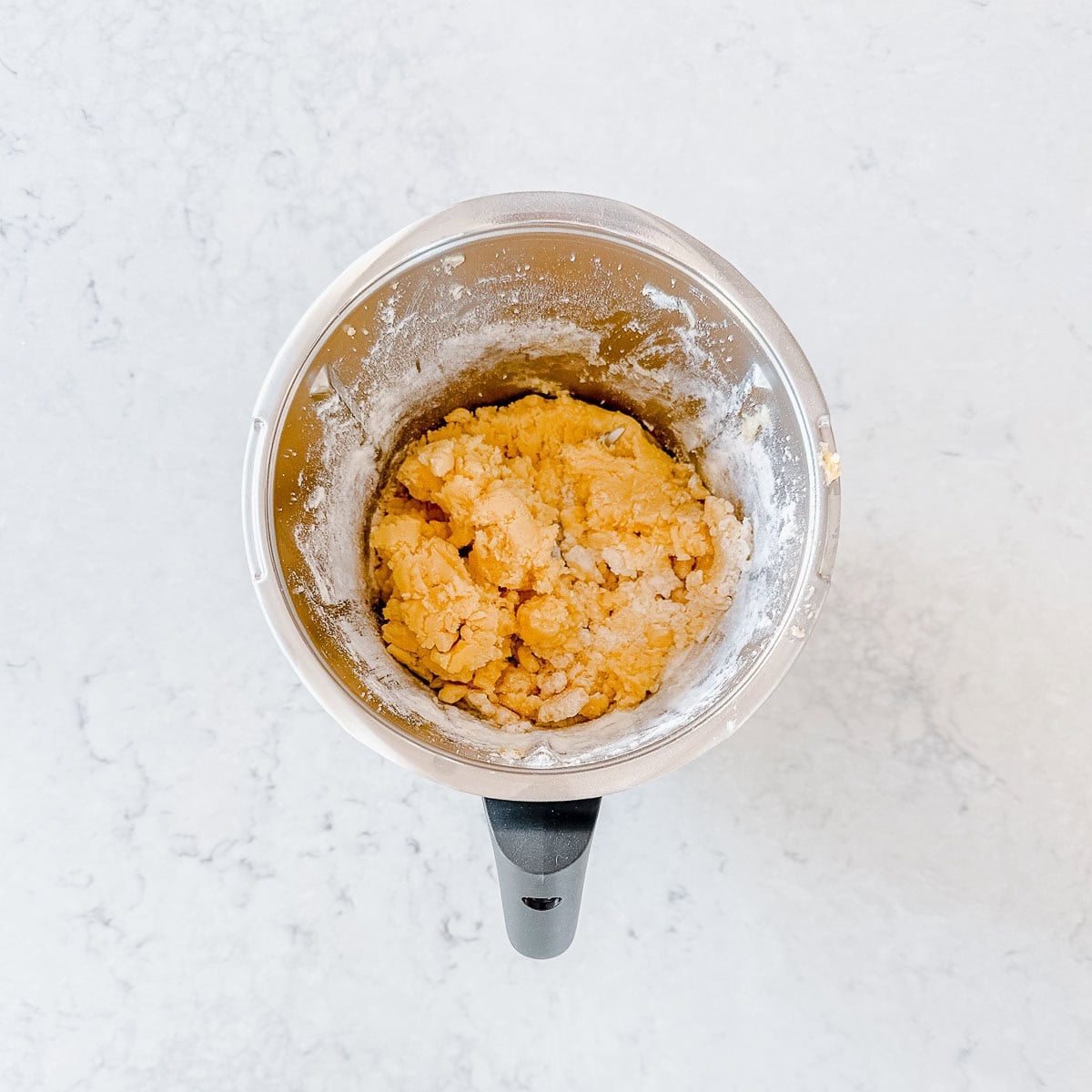 Sugar cookie dough in a Thermomix bowl.