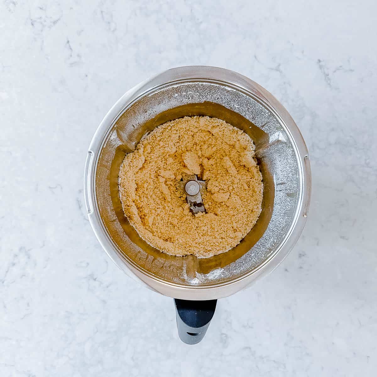 Butter and flour breadcrumbs in a Thermomix bowl.
