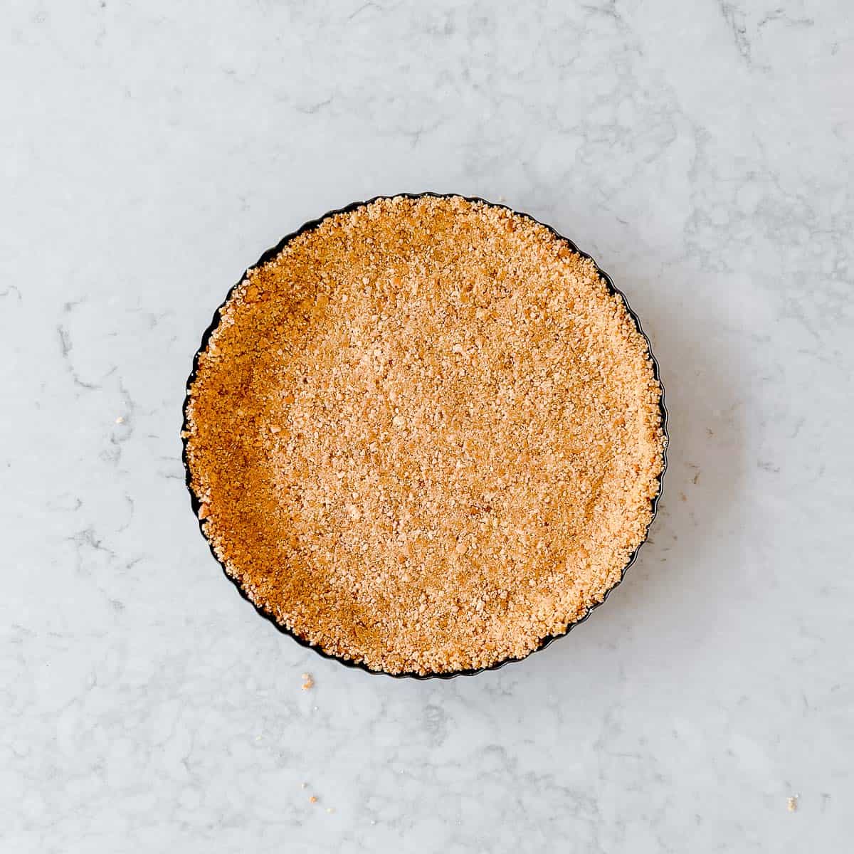 A digestive biscuit base in a tart tin.